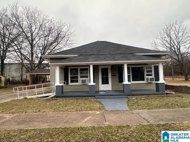 bungalow-style house with covered porch and a front yard