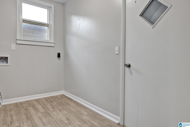 laundry area with washer hookup and light hardwood / wood-style floors