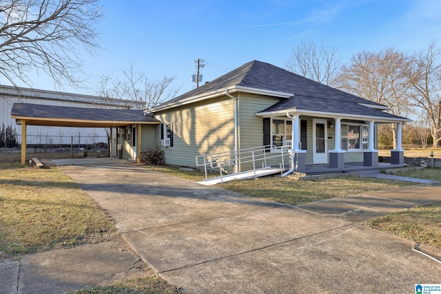 view of front of home with covered porch and a carport