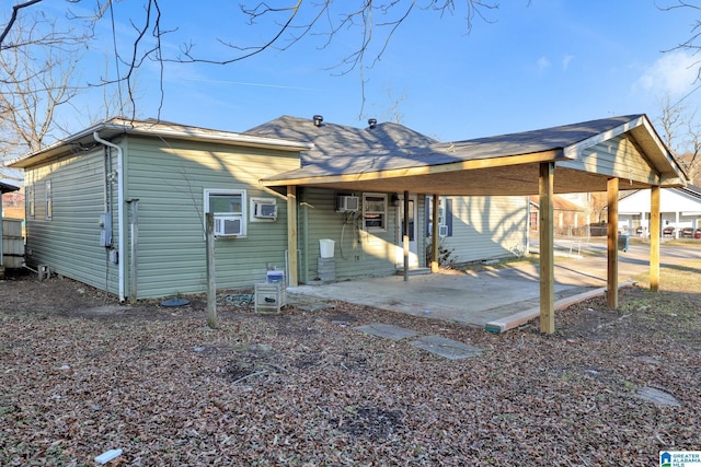 back of property with a patio and a wall mounted AC