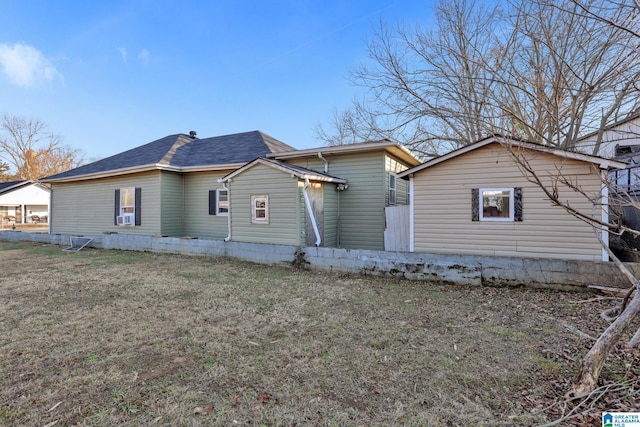 rear view of house featuring a lawn