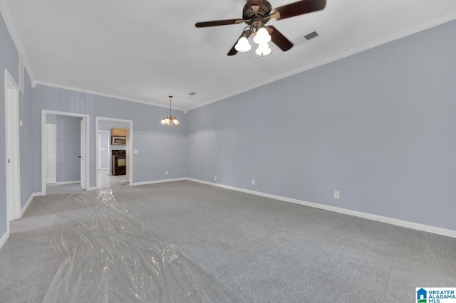 carpeted spare room with crown molding and ceiling fan with notable chandelier