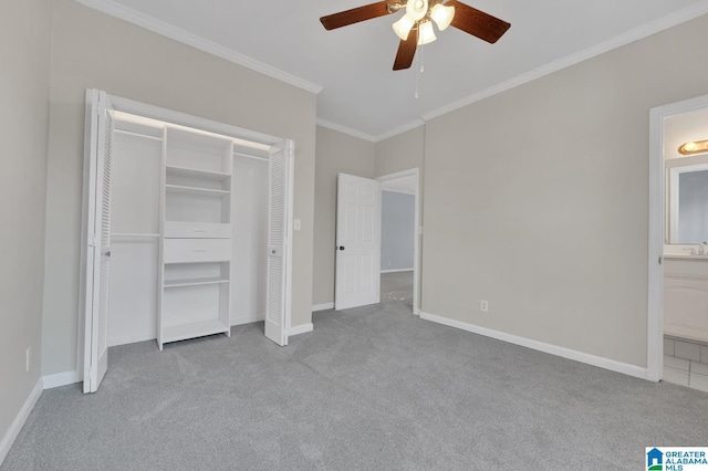 unfurnished bedroom with ceiling fan, ensuite bathroom, crown molding, light colored carpet, and a closet