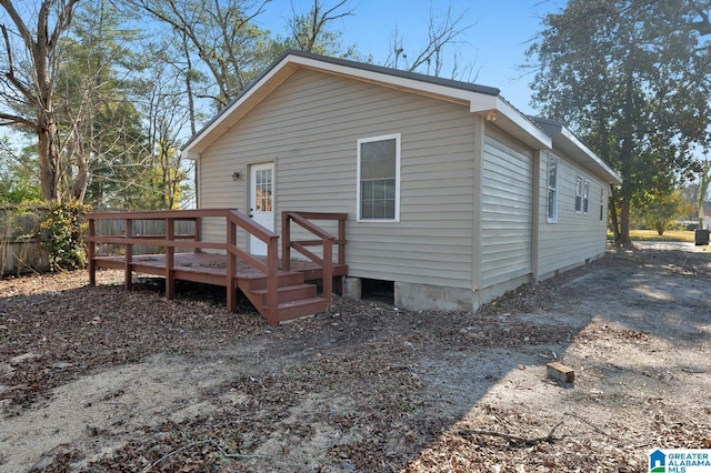 back of house with a deck