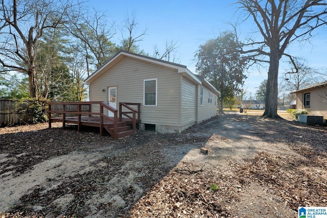 back of house with a wooden deck