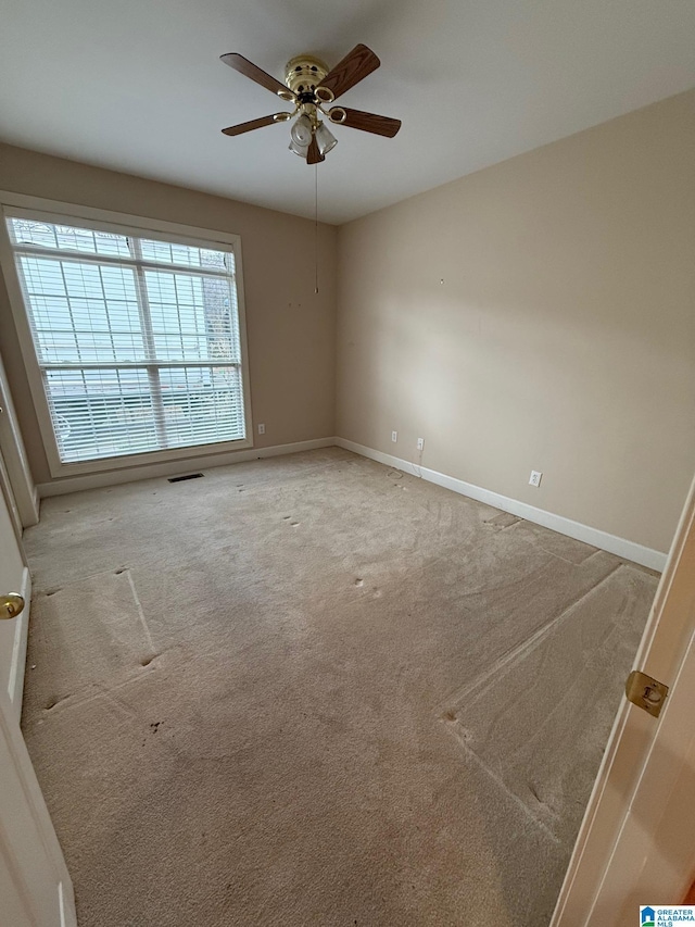 carpeted empty room with ceiling fan