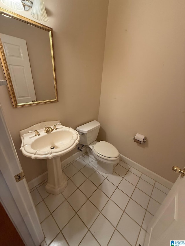 bathroom featuring tile patterned flooring and toilet