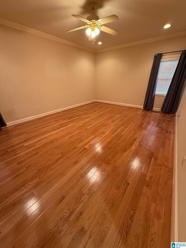 spare room with light wood-type flooring, ceiling fan, and ornamental molding