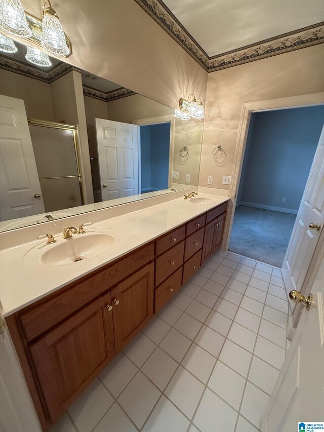 bathroom featuring tile patterned floors, vanity, and a shower with shower door