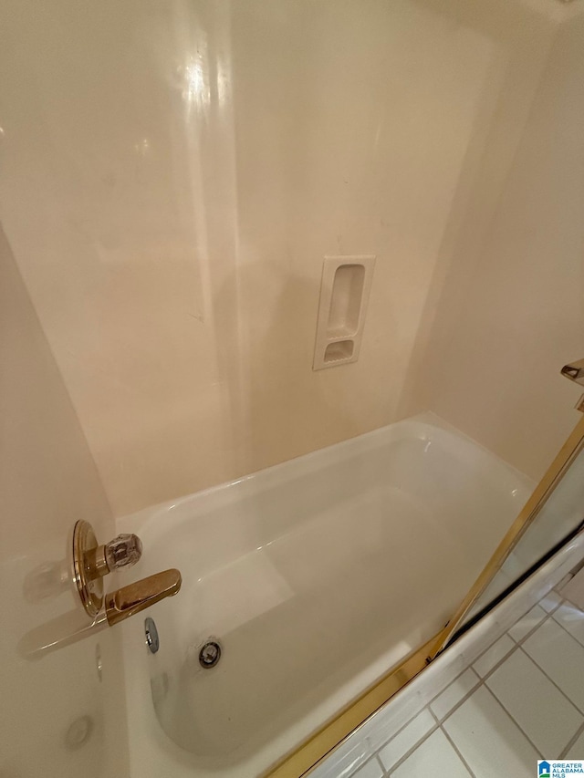 bathroom featuring tile patterned flooring and a washtub