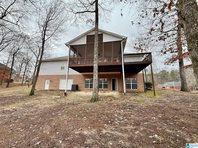 back of house with a sunroom, a deck, and central AC