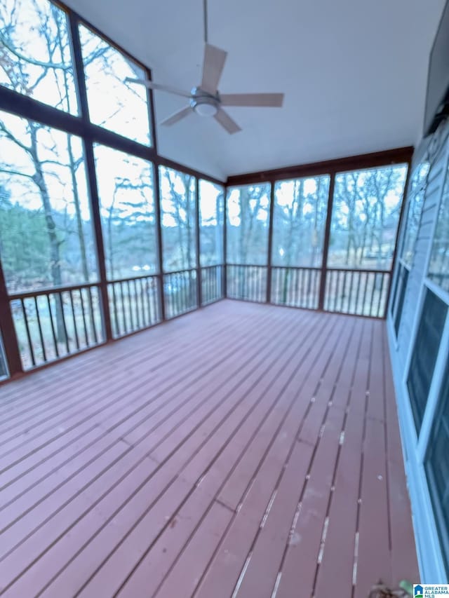 unfurnished sunroom featuring ceiling fan