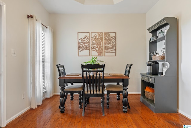 dining space with hardwood / wood-style floors