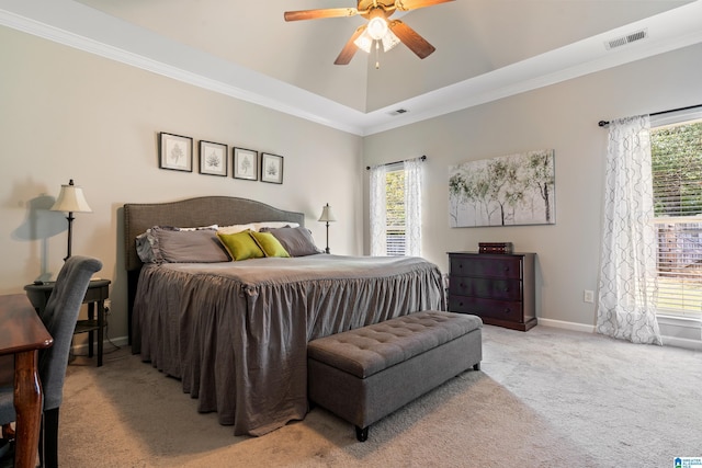 carpeted bedroom featuring ceiling fan, ornamental molding, and multiple windows