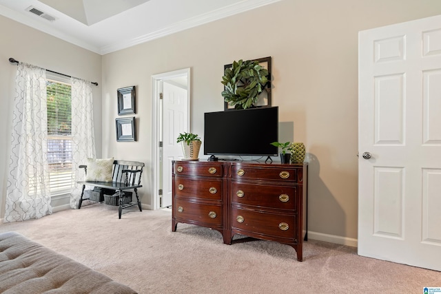 sitting room with ornamental molding and light carpet