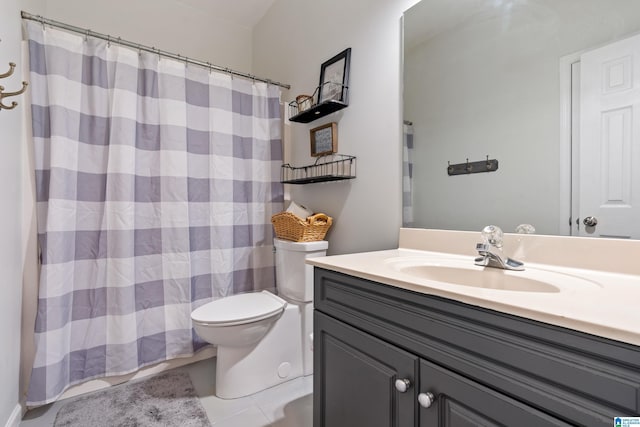 bathroom featuring tile patterned flooring, vanity, and toilet