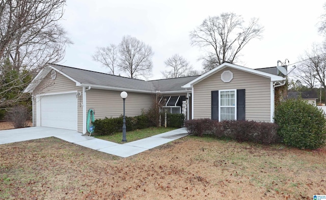 ranch-style house with a garage and a front lawn