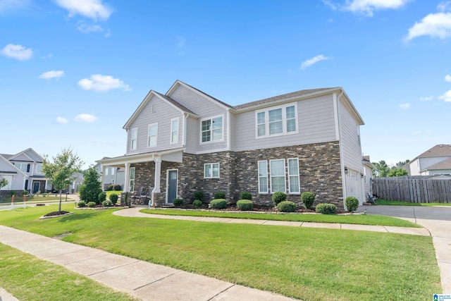 view of front of property with a front yard and a garage