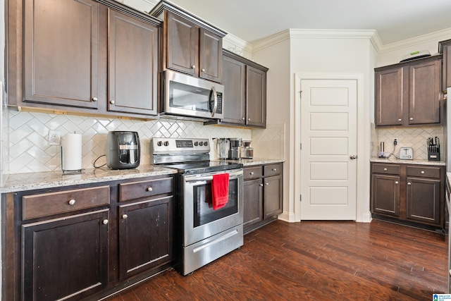 kitchen featuring dark brown cabinets, dark hardwood / wood-style flooring, decorative backsplash, and appliances with stainless steel finishes