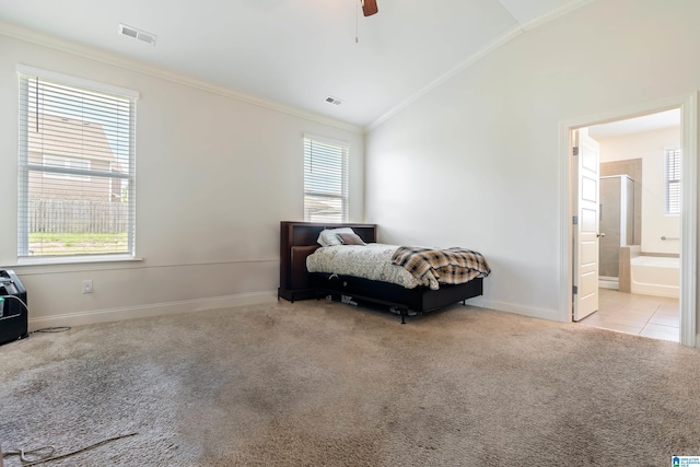 bedroom featuring ceiling fan, lofted ceiling, ensuite bathroom, and light carpet