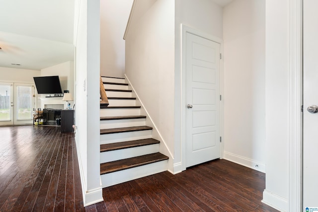 stairway with hardwood / wood-style flooring