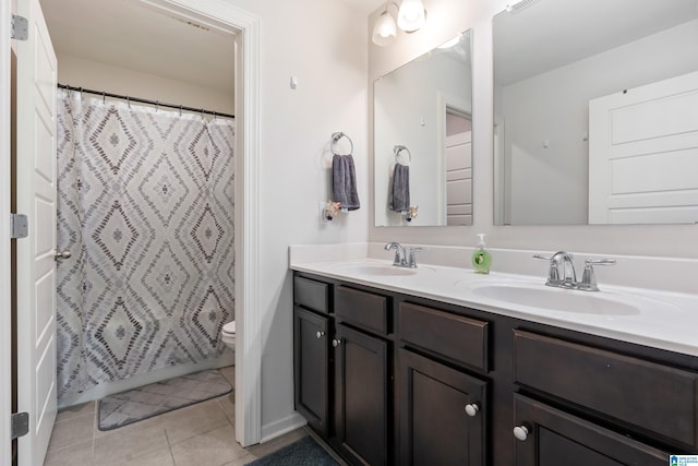 bathroom featuring tile patterned flooring, vanity, and toilet