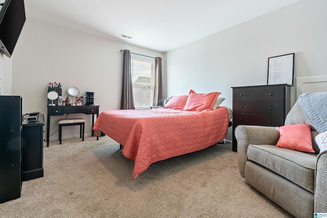 bedroom featuring light carpet