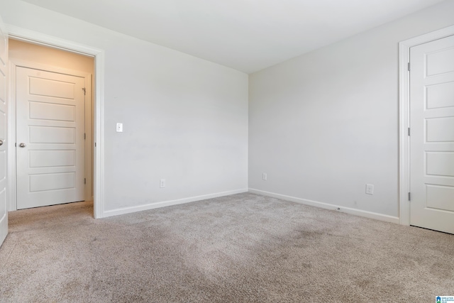 spare room featuring light colored carpet