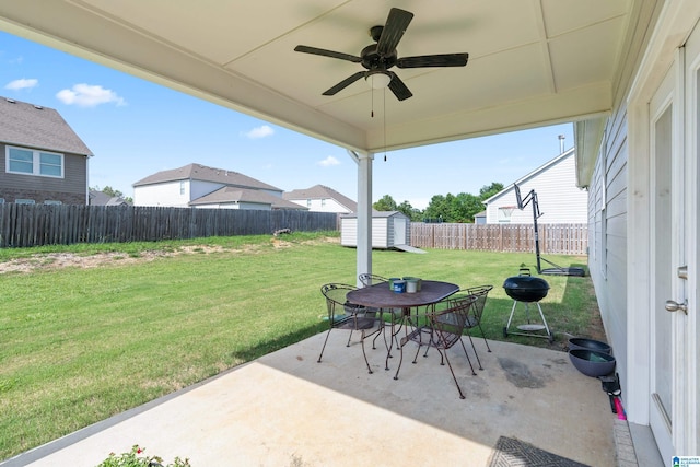 view of patio / terrace featuring ceiling fan and a shed