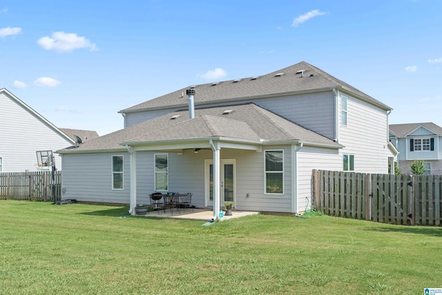 rear view of house with a patio area, ceiling fan, and a yard