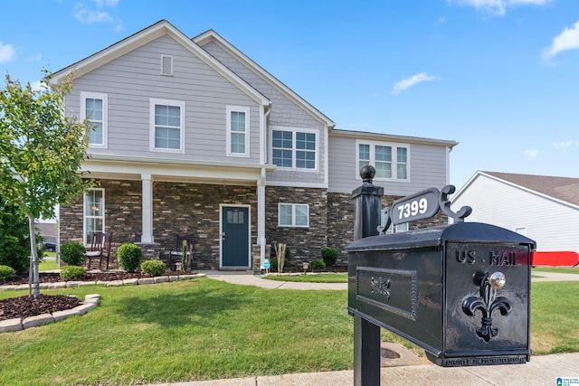 view of front of home featuring covered porch and a front lawn