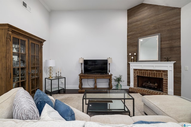 living room with hardwood / wood-style flooring, lofted ceiling, a fireplace, and wooden walls