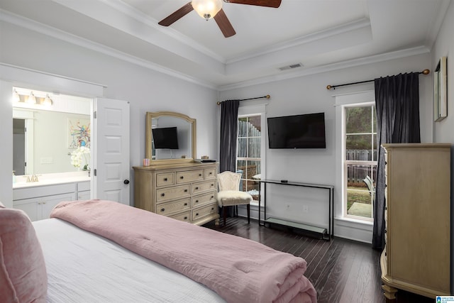 bedroom with connected bathroom, a raised ceiling, ceiling fan, and ornamental molding