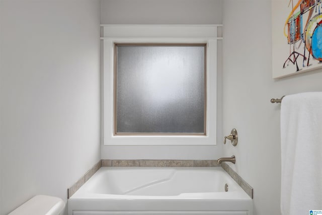 bathroom featuring a bathing tub and toilet