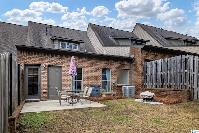 rear view of house with a yard, a patio, and cooling unit