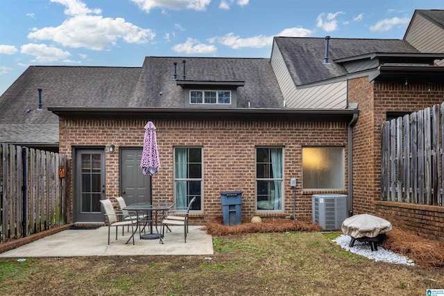 rear view of house featuring a patio area, a yard, and cooling unit