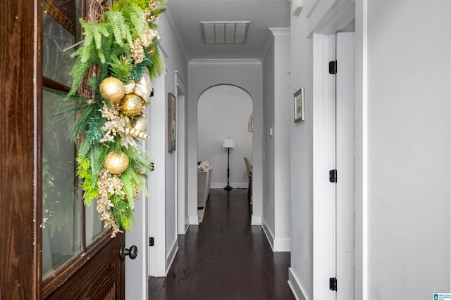 corridor with dark hardwood / wood-style flooring and crown molding