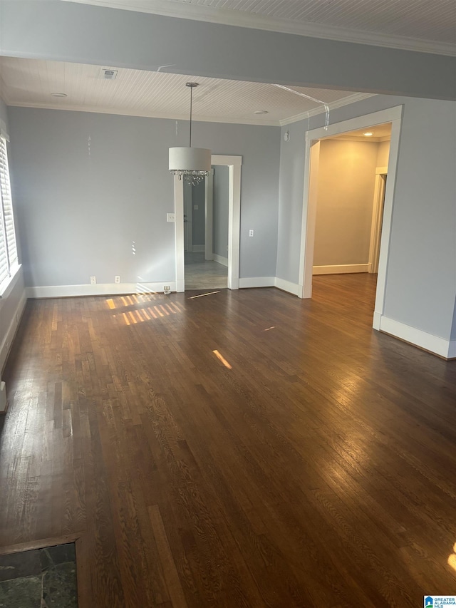 unfurnished room with crown molding and dark wood-type flooring