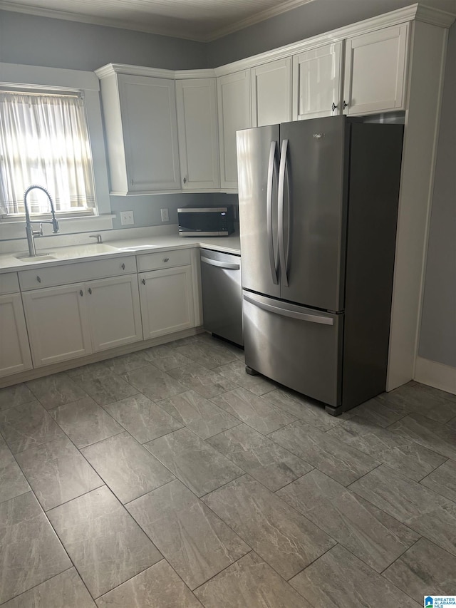 kitchen featuring white cabinetry, sink, crown molding, and appliances with stainless steel finishes