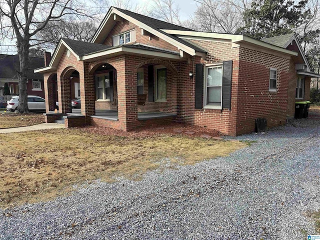 view of side of home with covered porch