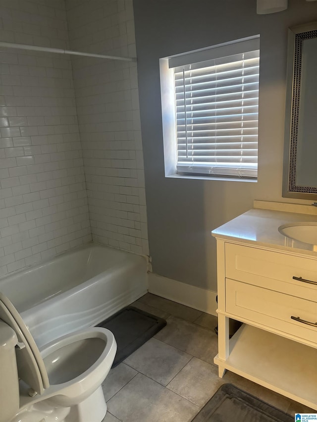 full bathroom featuring tile patterned floors, vanity, toilet, and tiled shower / bath combo