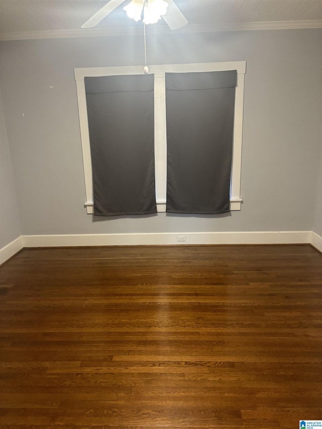 spare room with dark wood-type flooring, ceiling fan, and ornamental molding