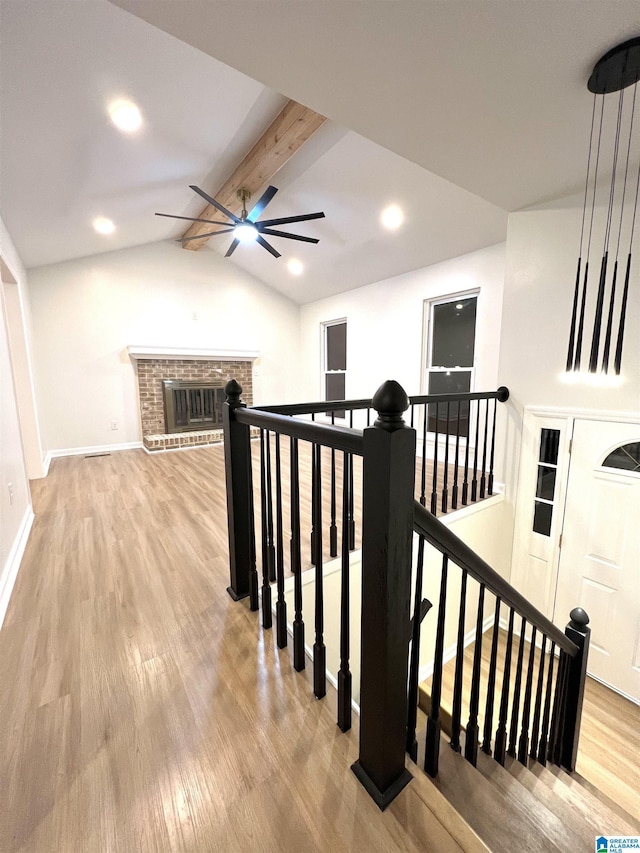 interior space with lofted ceiling with beams and wood-type flooring