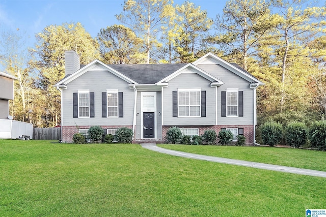 raised ranch featuring a front lawn