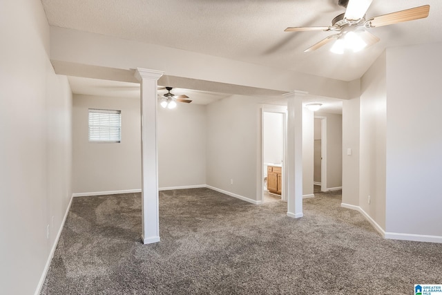 basement with dark colored carpet, a textured ceiling, and ceiling fan