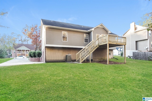 back of property featuring a lawn, a deck, and central air condition unit