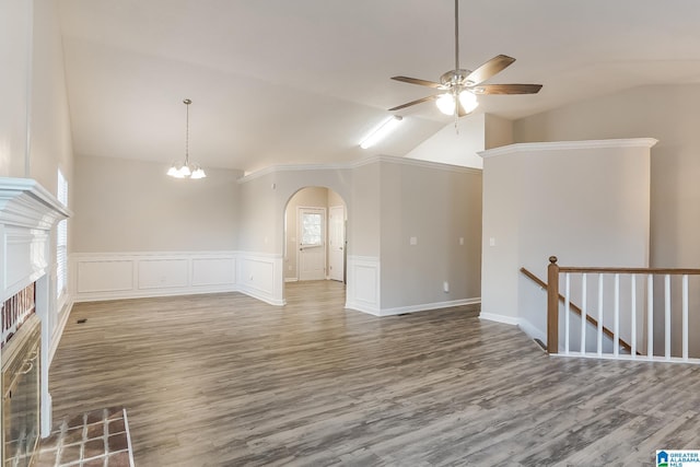 unfurnished living room featuring ceiling fan with notable chandelier, wood-type flooring, and lofted ceiling