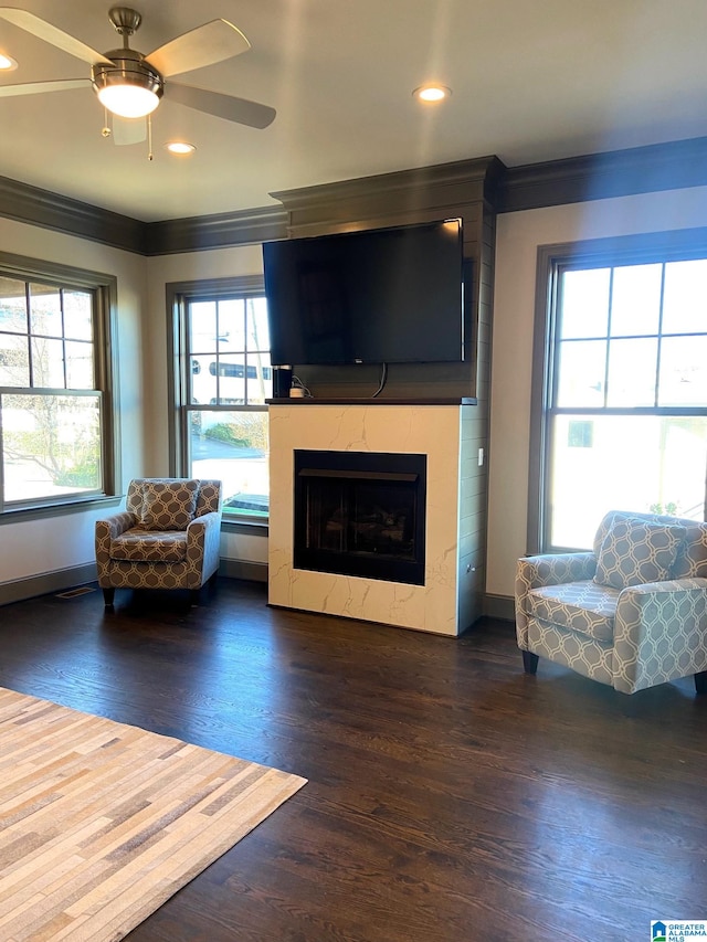 living room featuring ceiling fan, dark hardwood / wood-style flooring, and crown molding