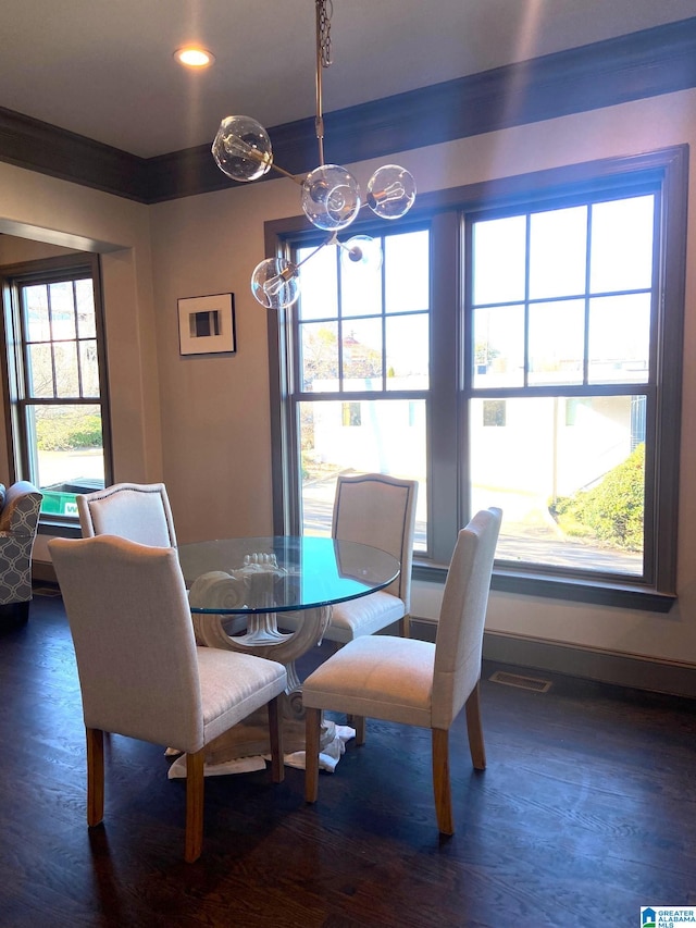 dining room with dark hardwood / wood-style flooring and ornamental molding