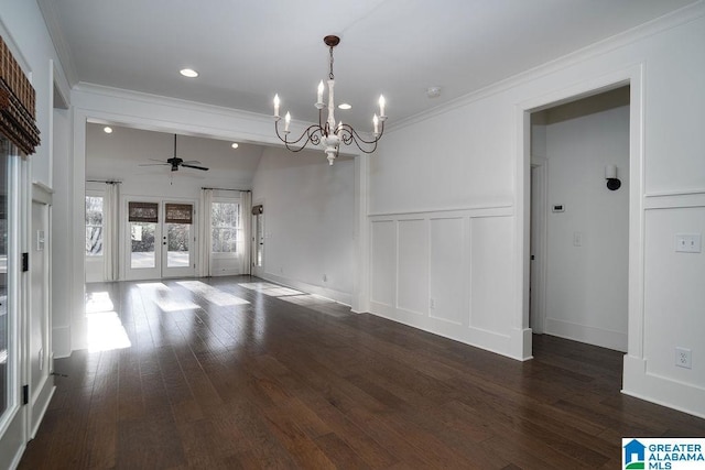 unfurnished dining area featuring french doors, dark hardwood / wood-style flooring, ceiling fan with notable chandelier, vaulted ceiling, and crown molding